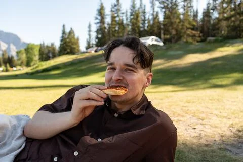 Man smiling while holding pizza Stock Photos