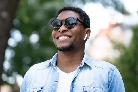 Man smiling while standing outdoors. Fotos de archivo
