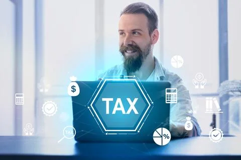 Man smiling while working on laptop with tax graphics and icons in a modern Stock Photos
