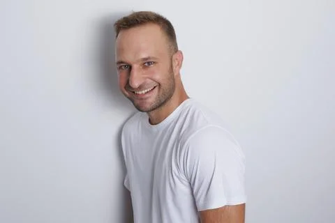 Man smiling in a white background with white t-shirt 写真素材