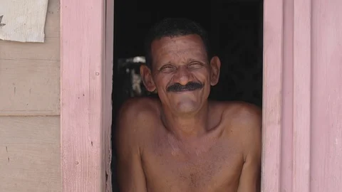 Man smiling at the window Baracoa Cuba Stock Footage 94391290