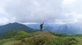 The man with a smoke bomb standing on a picturesque mountain 4k or 4k+ Resolution