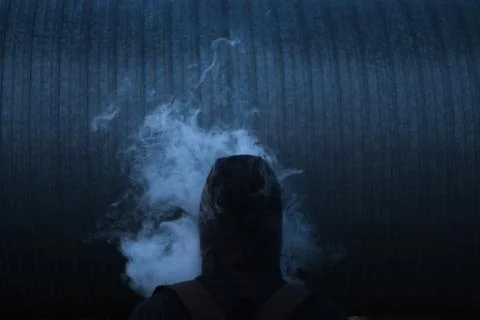Man in smoke on the dark background 写真素材