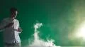The man smoke an electric cigarette and gesture on the green background Photo