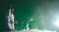 The man smoke an electric cigarette and gesture on the green background Photo