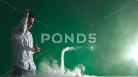 The man smoke an electric cigarette and gesture on the green background Stock Photos