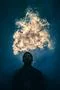 The man smoke an electric cigarette on the background of bright light Photo