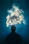 The man smoke an electric cigarette on the background of a bright light Photo