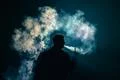 The man smoke an electric cigarette on the bright light background Photo
