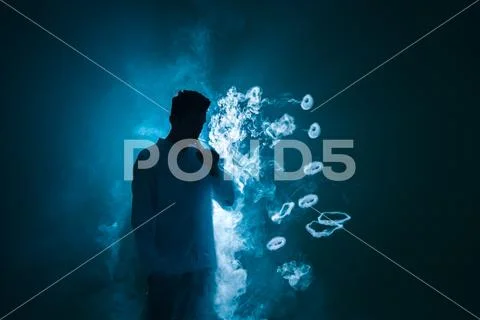 The man smoke an electric cigarette with a ring against the background of t.. Stock Photos