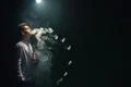 The man smoke an electric cigarette with a ring and on the dark background Photo