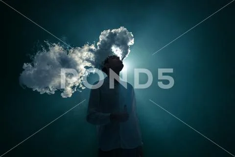 The man smoke an electrical cigarette on the dark background Stock Photos