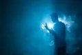 The man smoke an electrical cigarette with a ring on the dark background Photo