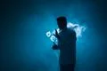 The man smoke an electrical cigarette with a ring against the background of.. Photo