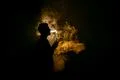 The man smoke an electronic cigarette against the background of the flame Photo