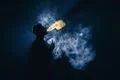 The man smoke an electronic cigarette against the background of the bright .. Photo