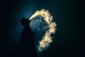 The man smoke an electronic cigarette against the background of the dark Photo