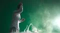 The man smoke an electronic cigarette and gesture on the green background Photo