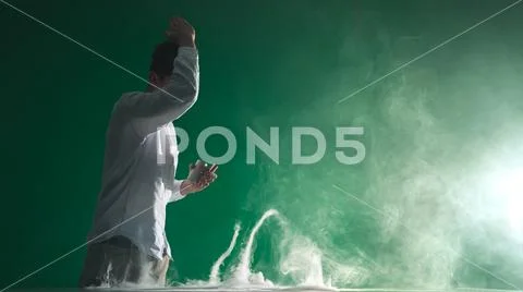 The man smoke an electronic cigarette and gesture on the green background Stock Photos
