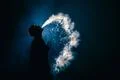 The man smoke an electronic cigarette on the background of the light Photo