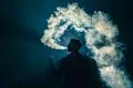 The man smoke an electronic cigarette on the bright light background Photo