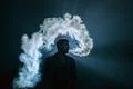 The man smoke an electronic cigarette on the bright light background Photo