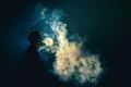 The man smoke an electronic cigarette on the dark background Photo