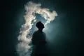 The man smoke an electronic cigarette on the dark background Photo