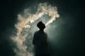 The man smoke an electronic cigarette on the dark background Photo