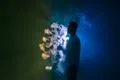 The man smoke an electronic cigarette with a ring against the dark background Photo
