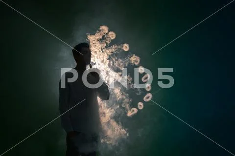 The man smoke an electronic cigarette with a ring against the background of.. Stock Photos