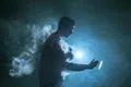 The man smoke an electronic cigarette with a ring on the dark background Photo