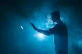The man smoke an electronic cigarette with a ring on the blue background Photo