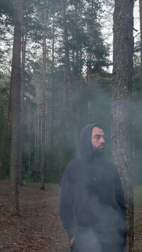 Man in the smoke from a fire in the forest Stock Footage 207712199