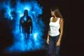 The man in smoke following the woman in the dark street Photo
