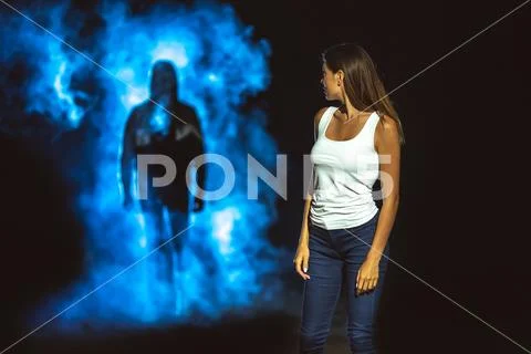 The man in smoke following the woman in the dark street Stock Photos