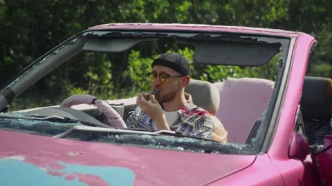 Man smokes cannabis in car using pipe. Stoned person smoking weed Stock Footage 233897528