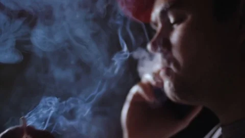 A man smokes a cigarette and talks on the phone. Stock Footage 78844751