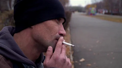 Man smokes a cigarette Stock Footage 99275751