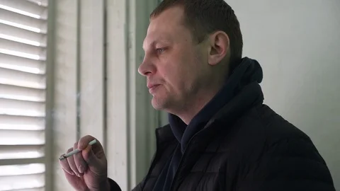 A man smokes a cigarette Stock Footage 122096404