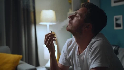Man Smokes A Cigarette On Sofa At Home Stock-Footage 112976968