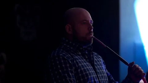 Man smokes in the dark Stock Footage 75262056