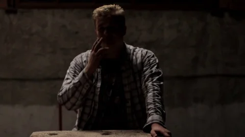 Man smokes in a dark room Stock Footage 71367466