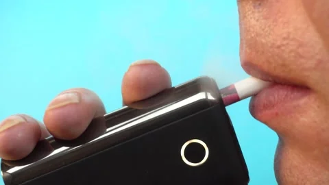 A man smokes an electronic cigarette, a bad habit causes health problems, close Stock-Footage 167636527