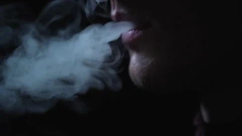 Man smokes an electronic cigarette in the dark. Vape. Stock Footage 236254949