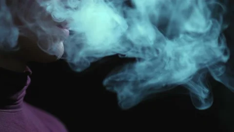 Man smokes an electronic cigarette in the dark. Vape. Stock Footage 236255020