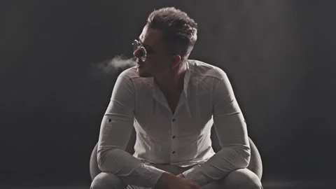 Man smokes an electronic cigarette Stock Footage 121580481