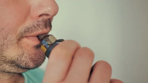 A man smokes an electronic cigarette Stock Footage 169532683