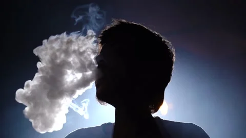 Man smokes hookah in bar background lights. smokes hookah exhaling clouds smoke. 스톡 동영상 149063207