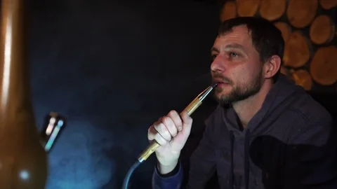 Man smokes hookah in a bar. Stock Footage 90431272